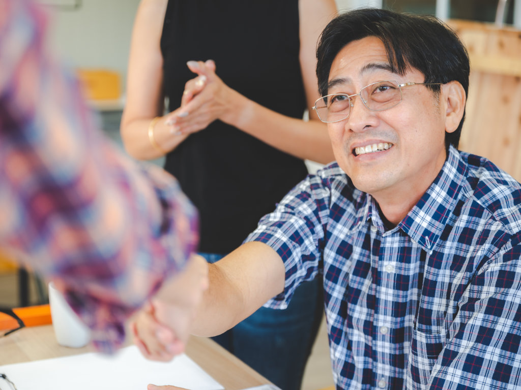 Man shaking hand with translator